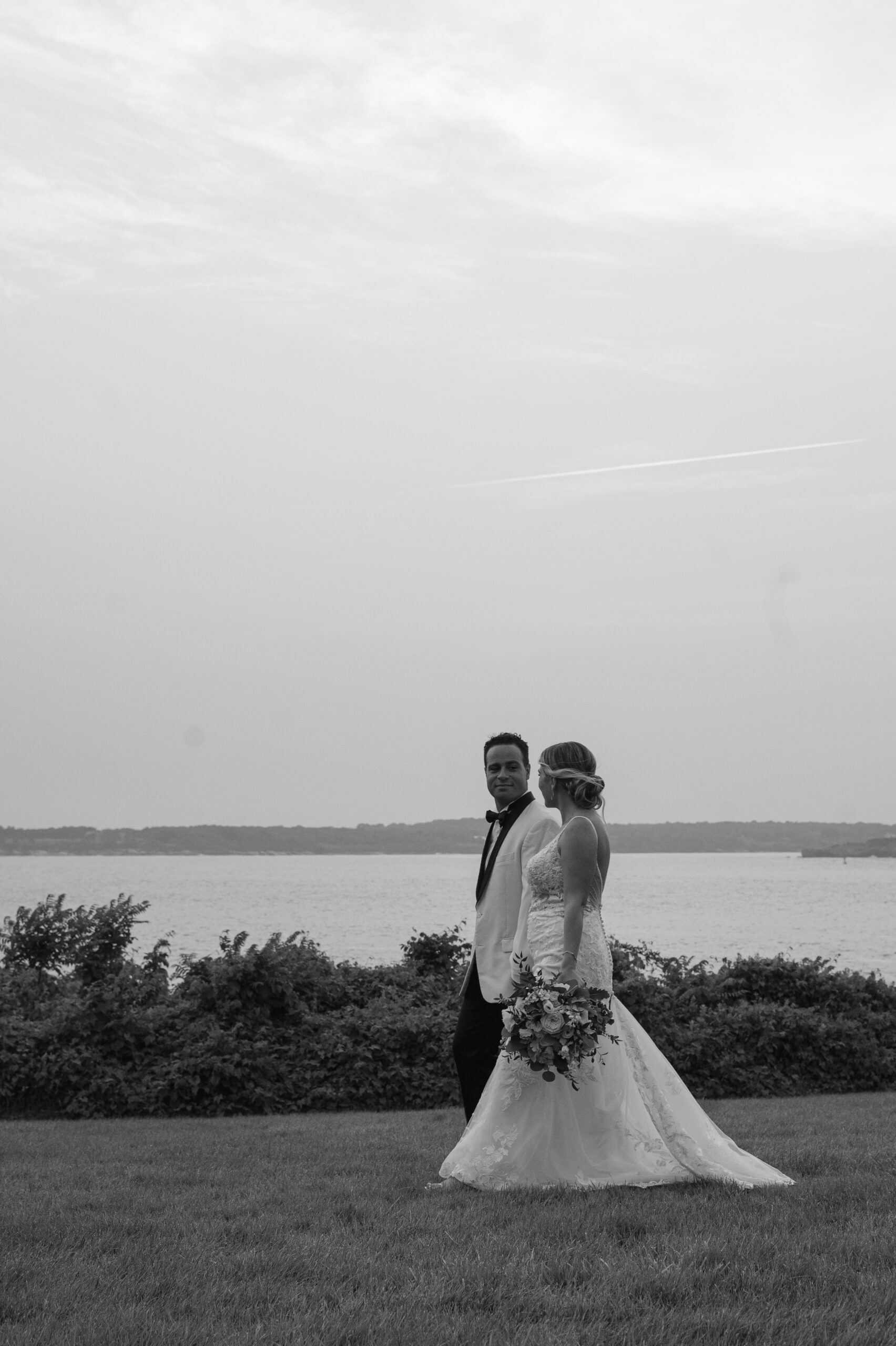 Couple walking by the water in Newport Rhode Island wedding