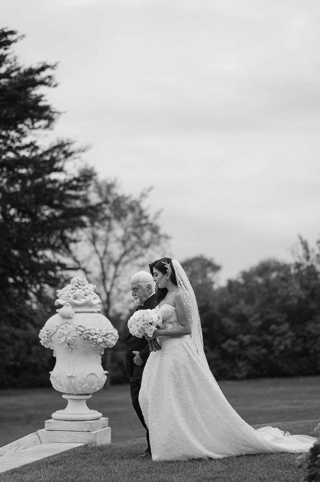 Bride walking down the aisle with dad at Rosecliff Mansion wedding ceremony in Newport Rhode Island